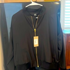 Black nylon bomber jacket . Gold accent zipper.  Never worn NWT